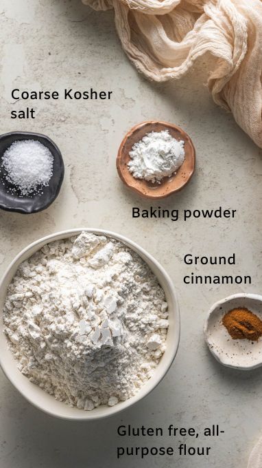 This image shows coarse kosher salt, baking powder, ground cinnamon, and gluten free all purpose flour in individual bowls