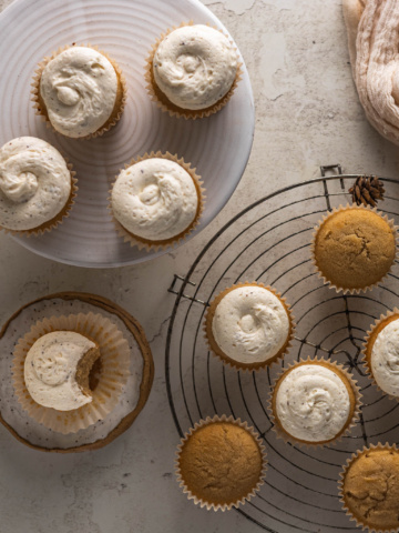 This image shows the finished gluten free maple cupcakes with brown butter cream cheese frosting on them.