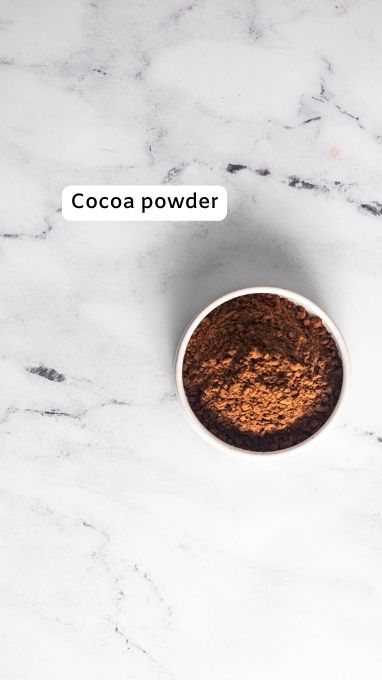 Cocoa powder in a bowl for peppermint brownie cookies
