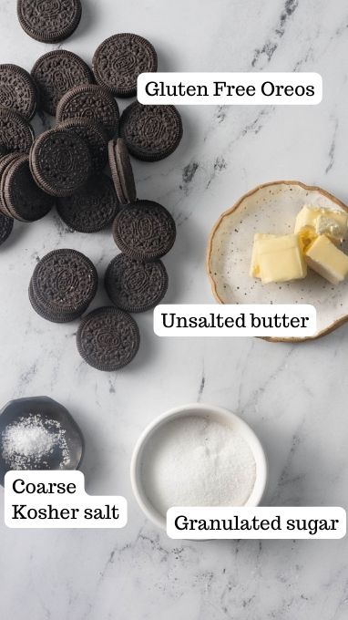 Crust ingredients for the gluten free oreo cheesecake. This image shows oreos laid out on a counter with butter, granulated sugar and salt.