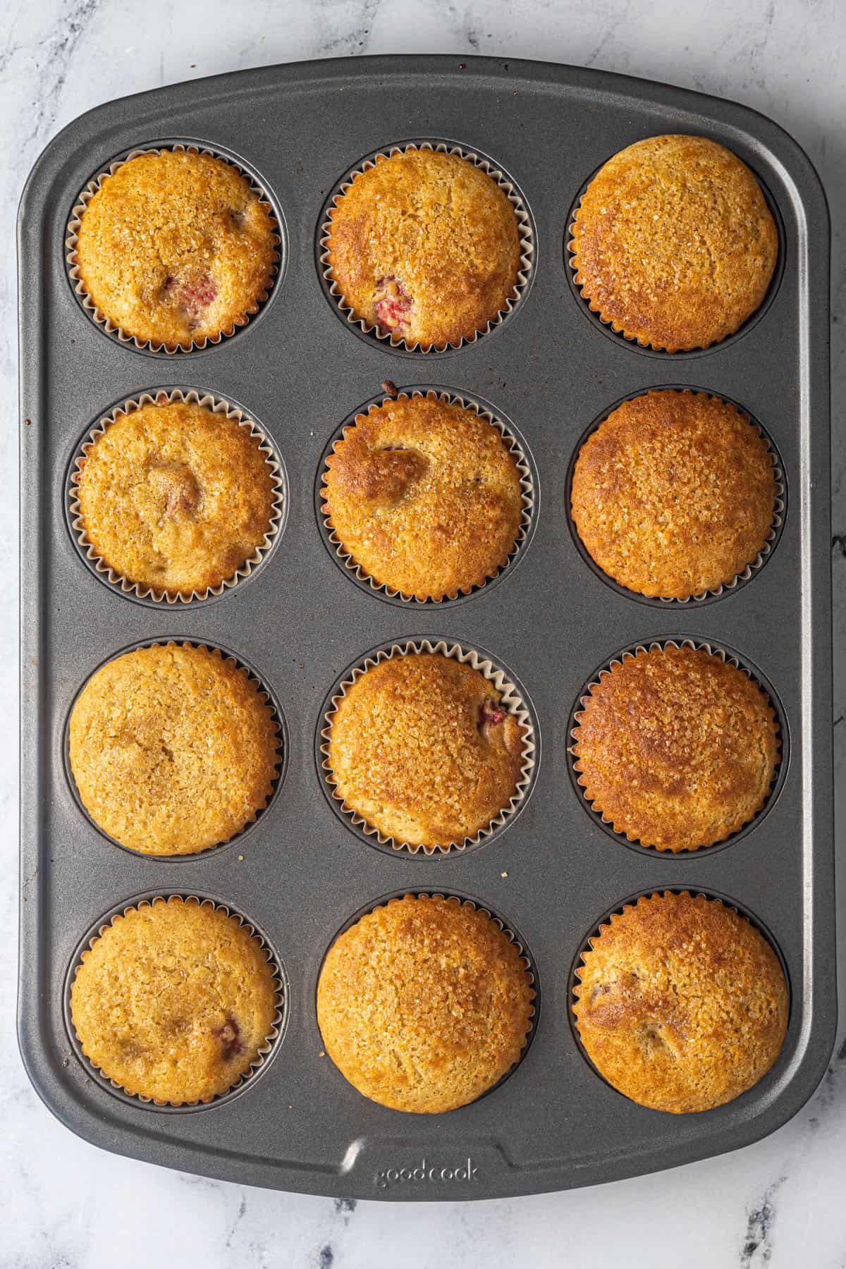 This image shows the finished Gluten Free Raspberry Muffins. They have been baked and are cooling.