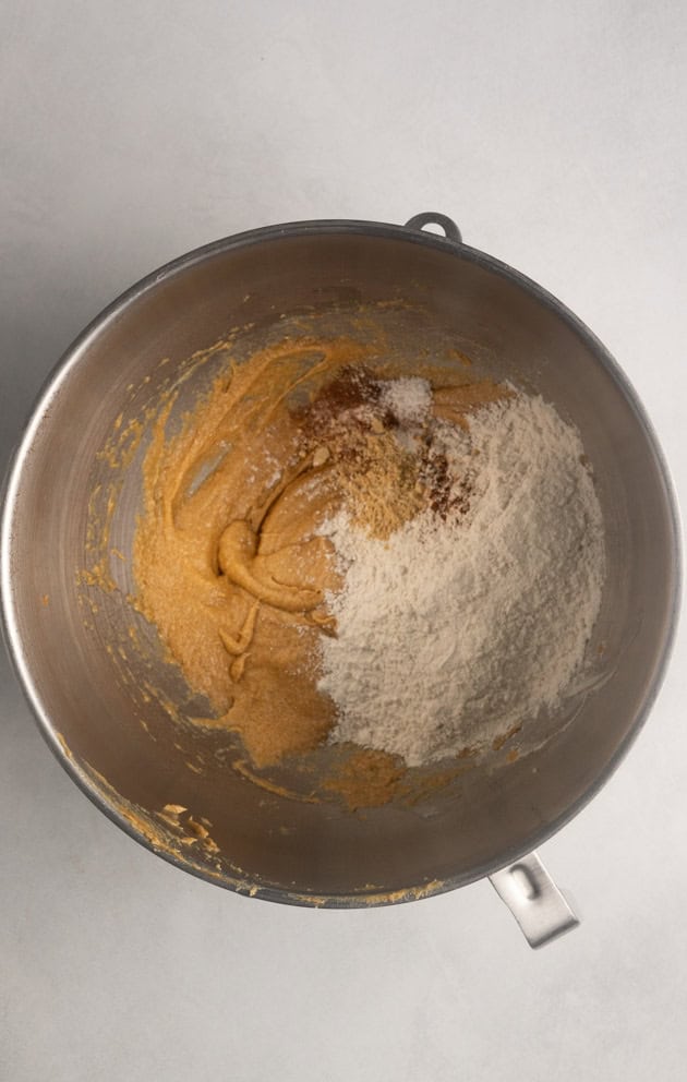 This image shows the process for making gluten-free gingersnaps. This image shows the dry ingredients being added to the cookie dough.
