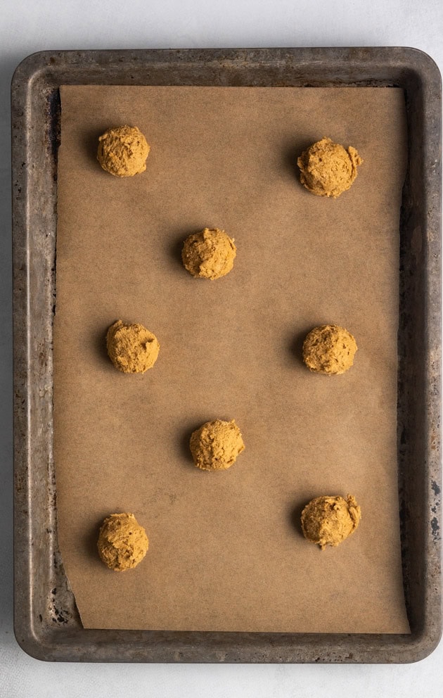 This image shows the gluten-free gingersnap dough once it has been scooped and chilled. This image shows the dough that has been placed on a cookie sheet and ready to be baked.