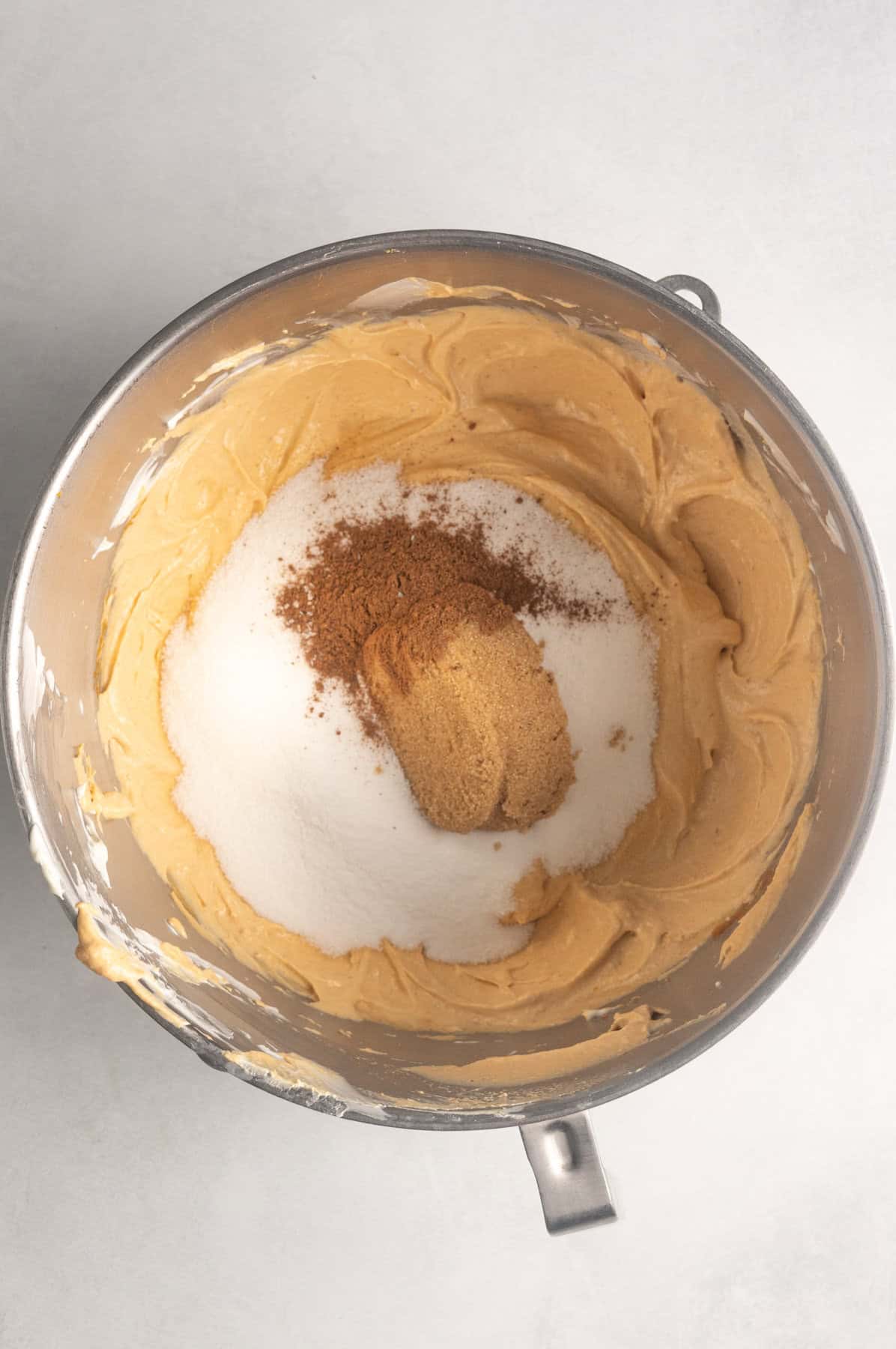 Granulated sugar, salt, and pumpkin pie spice are added to the gluten free pumpkin cheesecake filling.