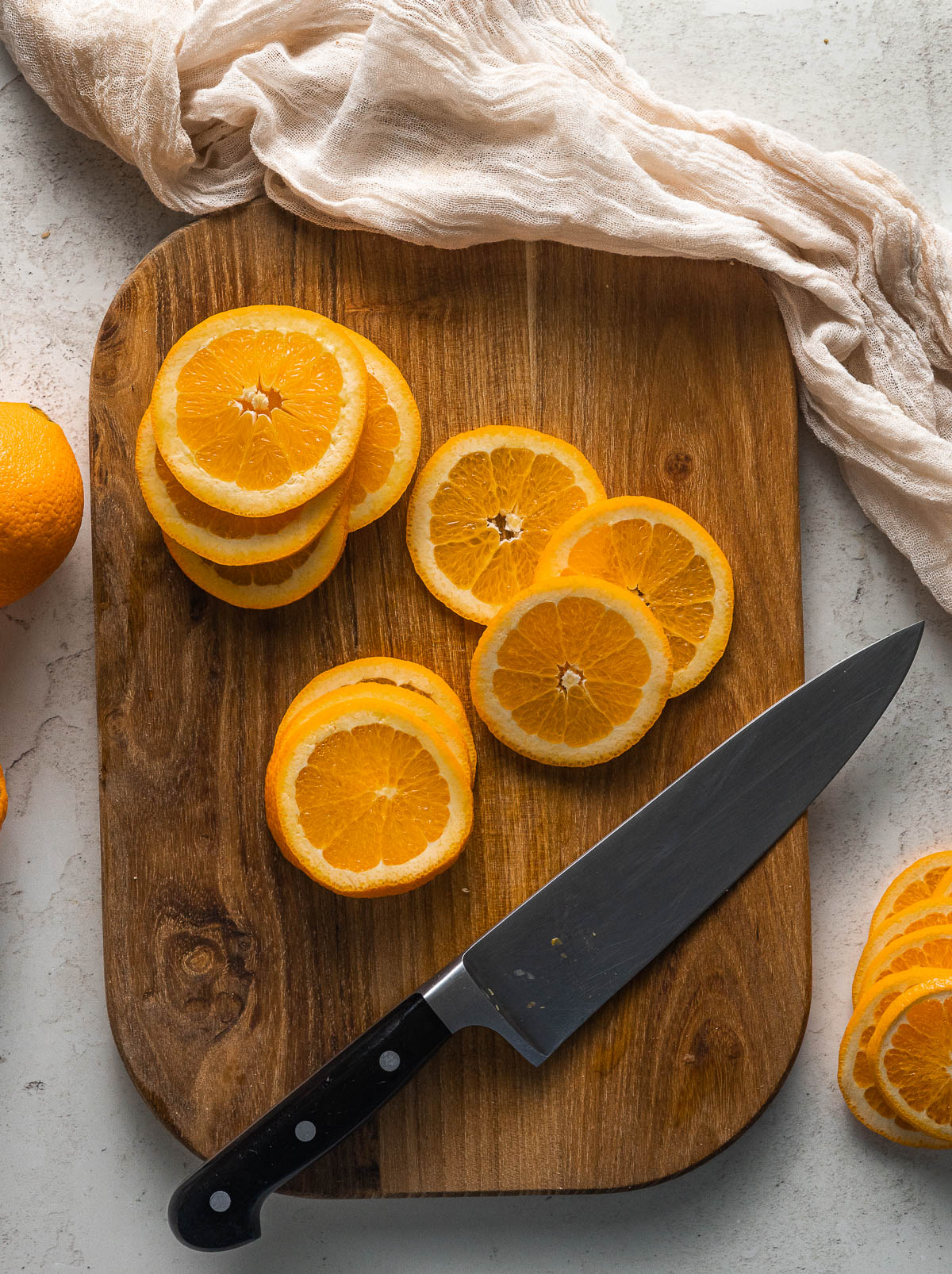 Fresh navel oranges being sliced for the dried orange slices