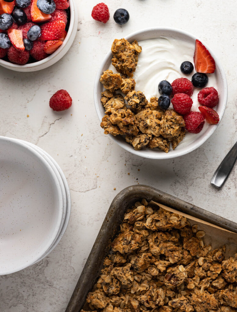 Serving of peanut butter granola clusters with yogurt and mixed berries